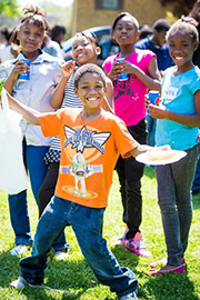 Happy children posing together outside.