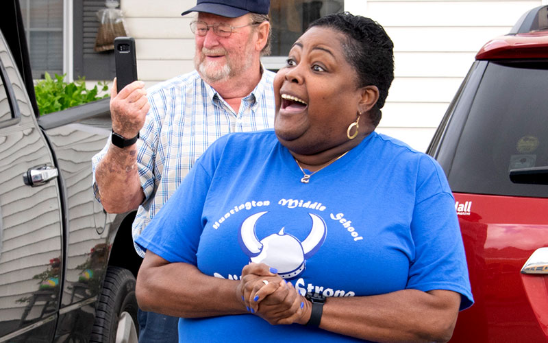 Angela Ellsworth-Fair reacts to the arrival of the Prize Patrol bus.